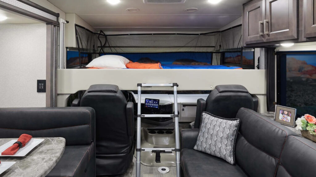 the inside living and driving area of a thor outlaw class a motorhome toy hauler