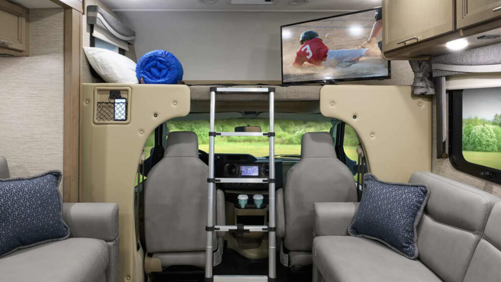 the inside living and driving area of a thor outlaw class c motorhome toy hauler