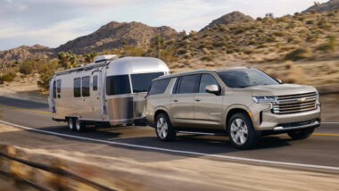 A suburban towing an RV with an impressive towing capacity