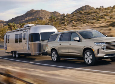 A suburban towing an RV with an impressive towing capacity