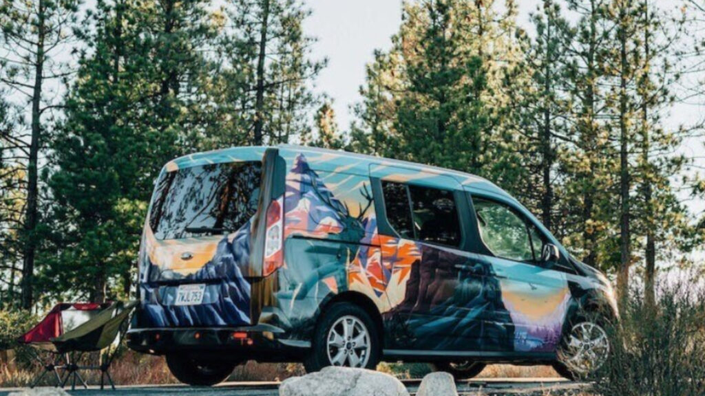 A Santa Cruz Escape Camper Van parked in the woods