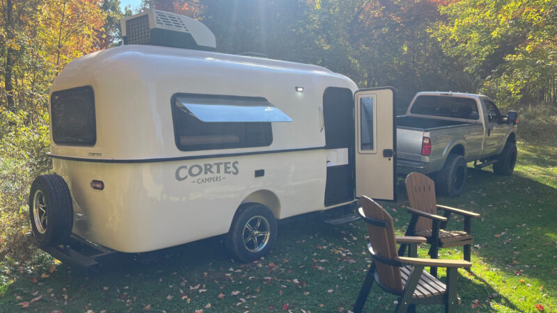 A Cortes Camper being towed by a truck