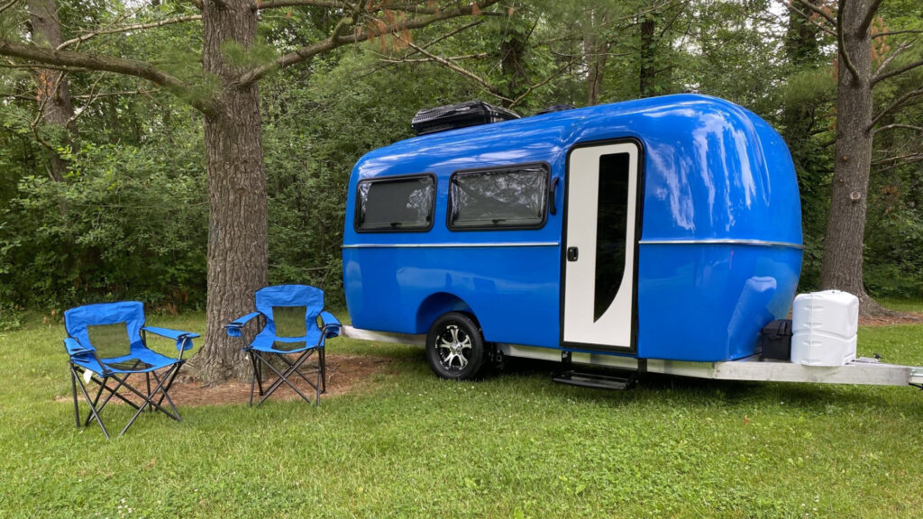 A blue Cortes Camper at a campsite