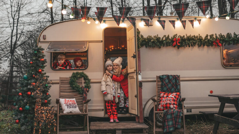 Children outside their RV decorated for Christmas