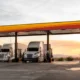 Semis getting gas at a Love's gas station, which now offers full RV hookups