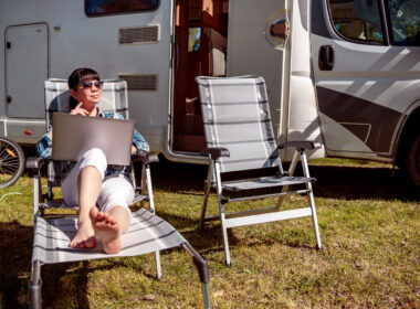 A woman working by her RV, deciding if living in an RV is her retirement dream