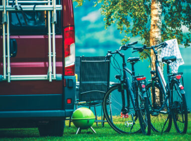 An RV next to bikes that were brought along using an RV ladder bike rack