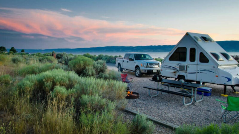 An Aliner luxury pop up camper parked outside