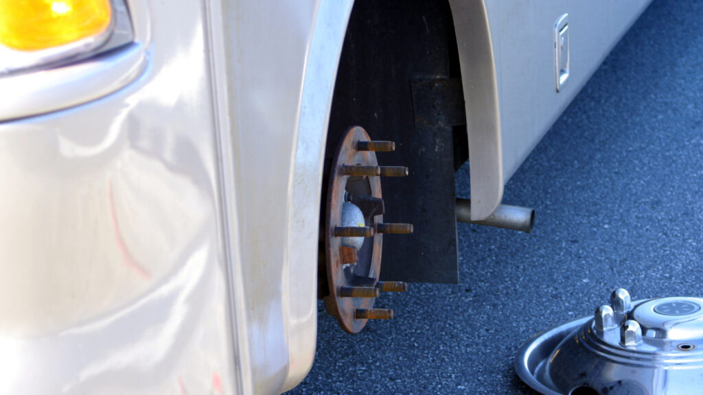 A wheel removed during a trailer bearing grease process