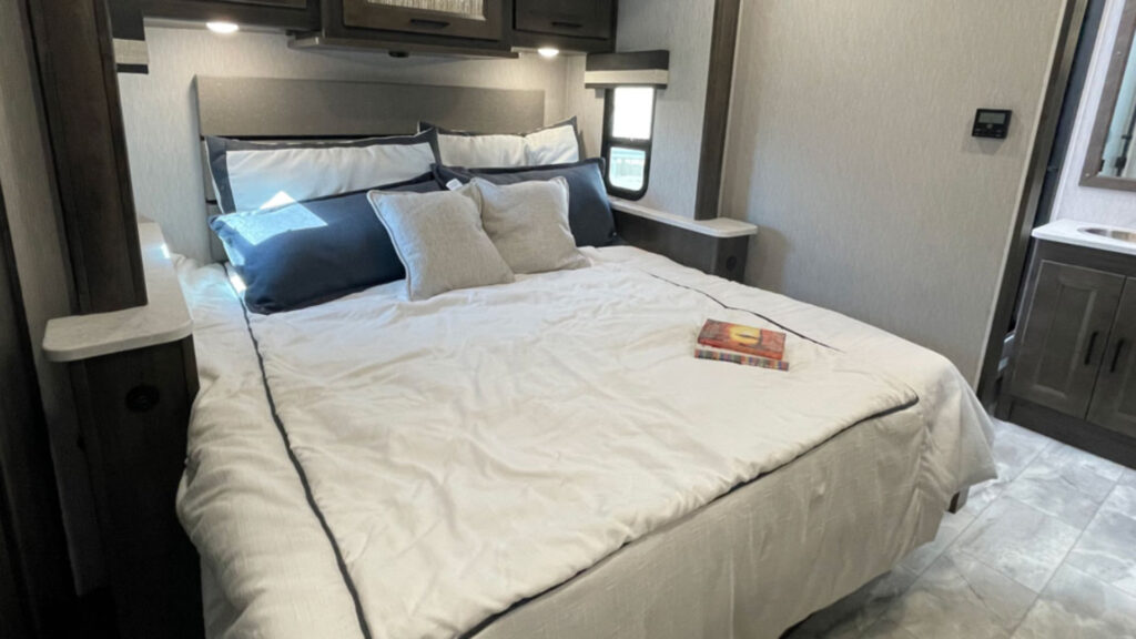 A bed inside a Coachmen Mirada 35ES that can sleep up to 10 people
