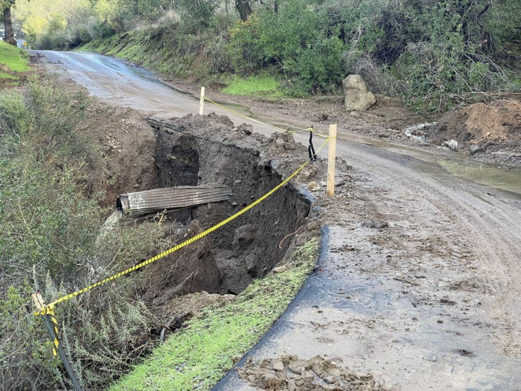 Washed out roads with caution tape in Rancho Oso RV Park 