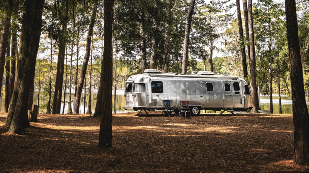 An Airstream trailer out in the woods
