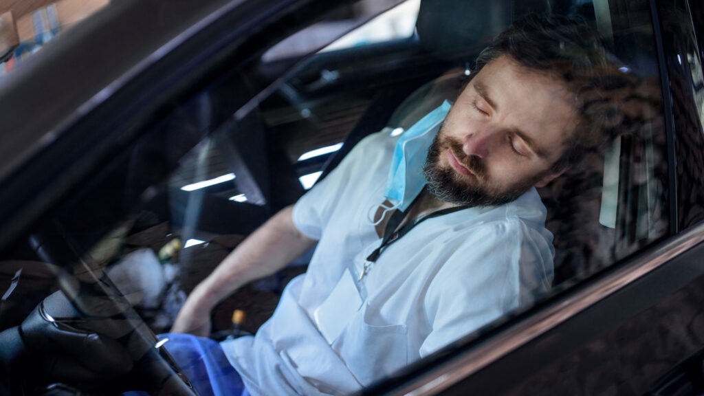 A man sleeping in his car