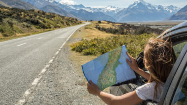 A woman looking at a map on her road trip