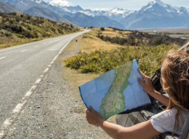 A woman looking at a map on her road trip