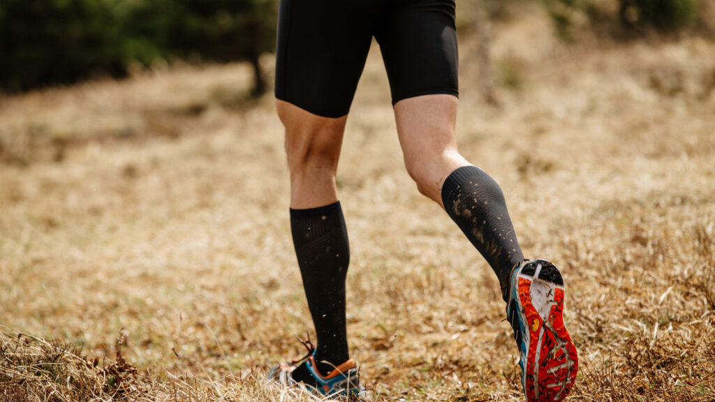 A man running with compression socks on his road trip