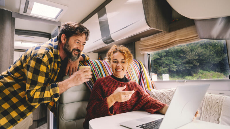 A couple inside their RV budgeting