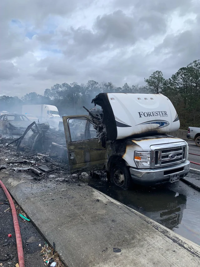 A totaled RV after being on fire on the freeway