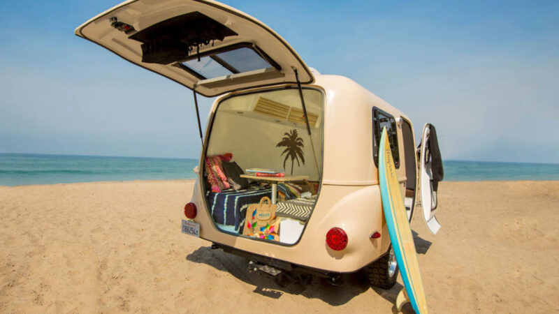 A vintage Happier Camper motorhome on the beach