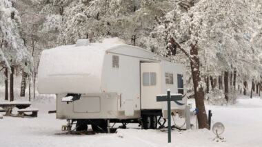 An RV without RV skirting at a campground in the winter