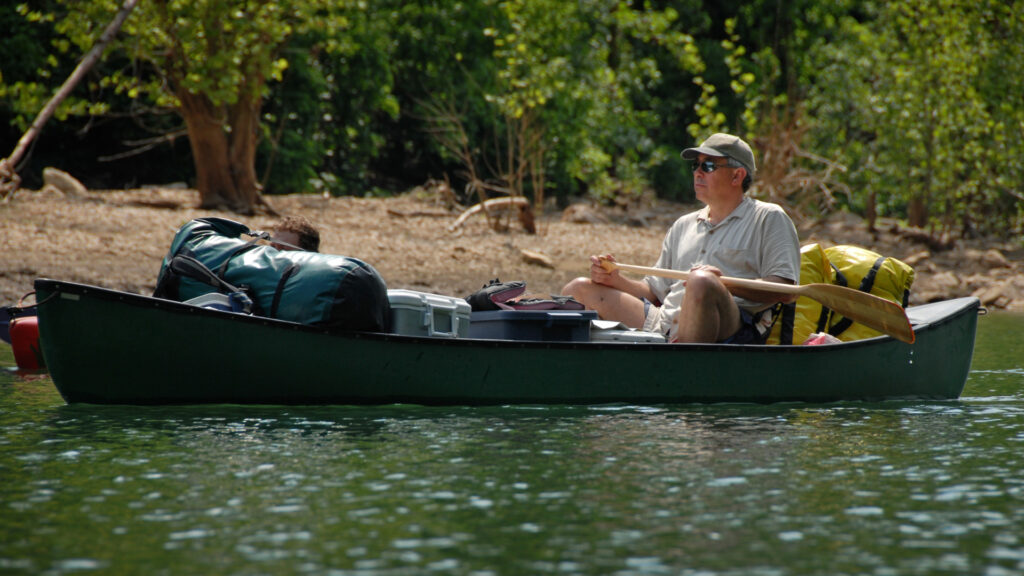 A man in his canoe on a camping trip