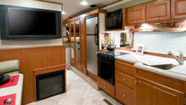 Inside an RV with a fridge in the kitchen
