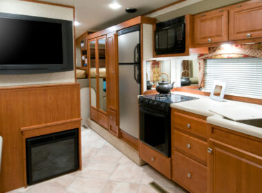 Inside an RV with a fridge in the kitchen