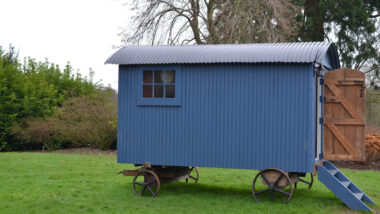 A blue Shepherd's Hut outside