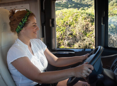 A woman driving her RV without a seatbelt