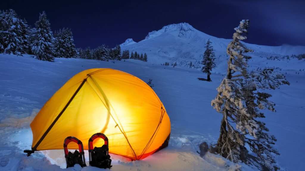 A tent outside in the winter keeping a camper warm using a tent heater
