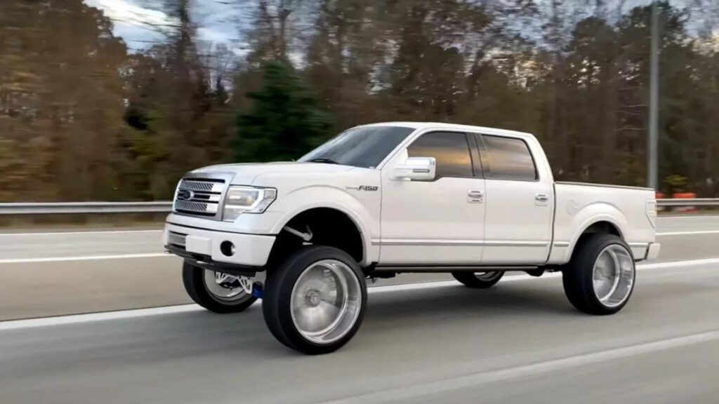 A squatted F150 truck on the road