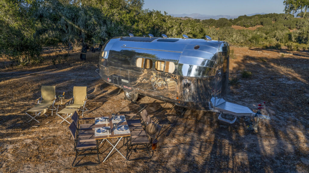 A Bowlus travel trailer parked at a campsite