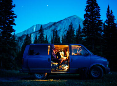 A person sitting in their van at night
