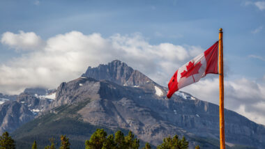 View of a Canadian flag by a mountain