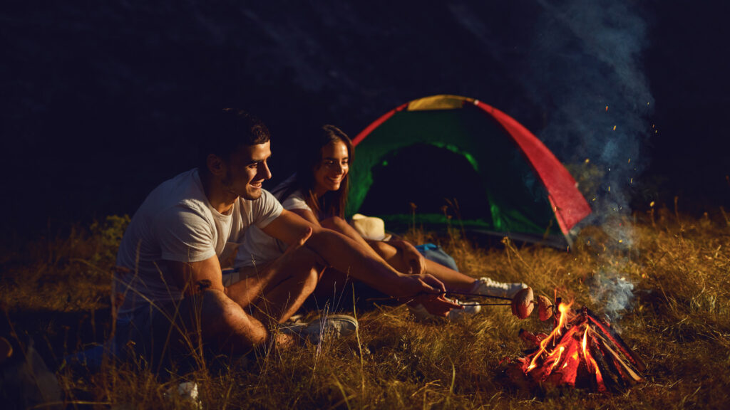 A couple staying to stay cool while camping in the summer