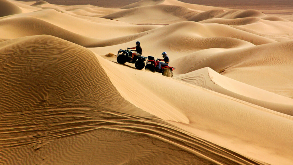 People off-roading on four wheelers at killpecker sand dunes