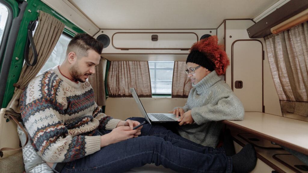 A couple inside their RV researching rigs