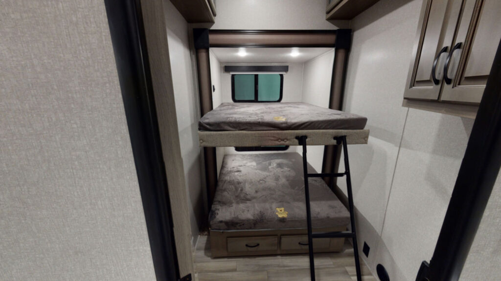 A bunk bed with stairs inside a Coachmen Chaparral 373MBRB