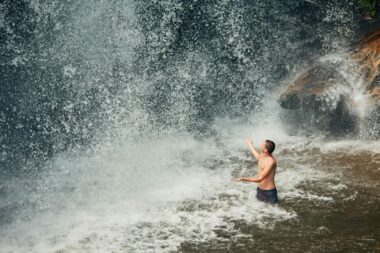 Man swimming in waterfall in NY