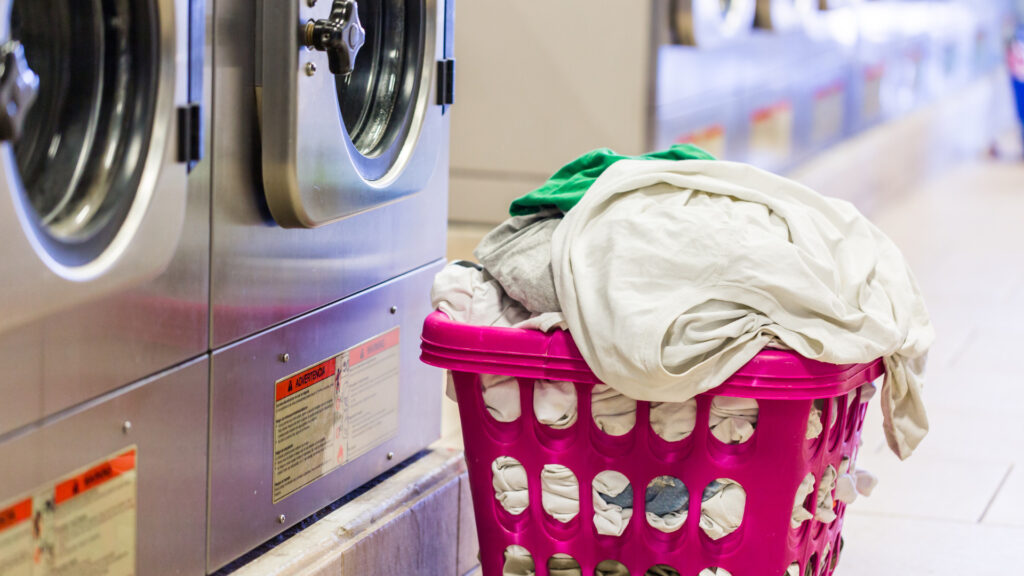 Image of clothing in a laundry basket at a laundromat