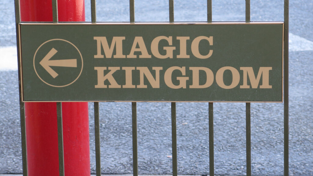 Sign pointing to magic kingdom, where you can visit while staying at one of the best campgrounds for kids
