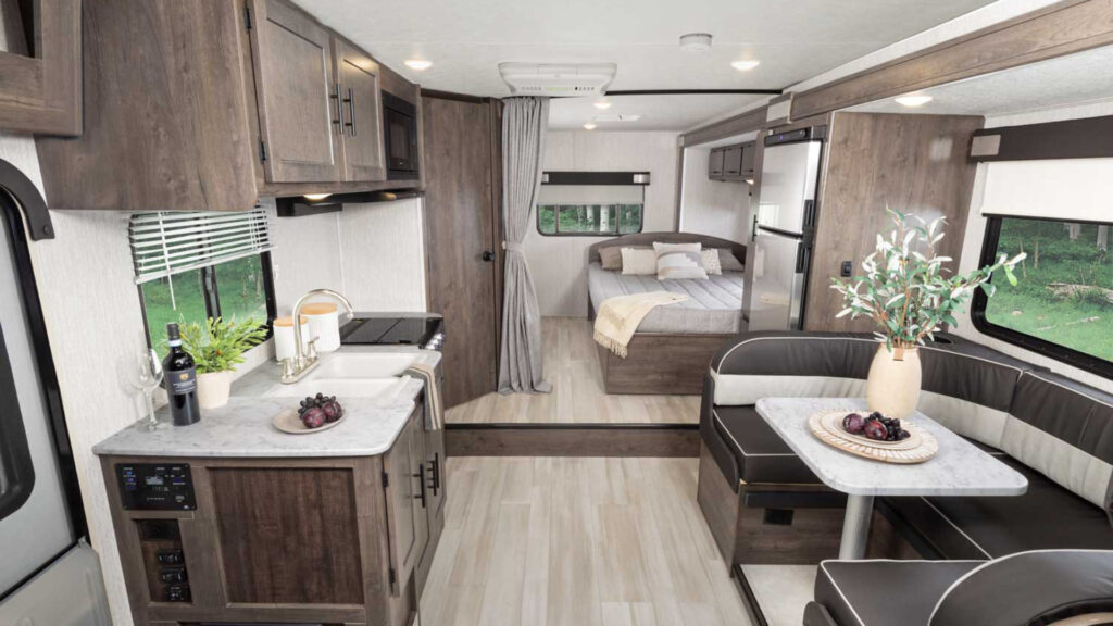 View of the bedroom and kitchen area inside a coachmen leprechaun class C RV