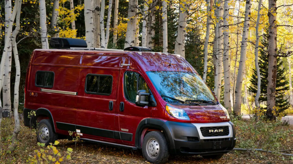 A winnebago camper van in the woods