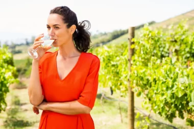 Woman drinking glass of wine in Colorado winery vineyards