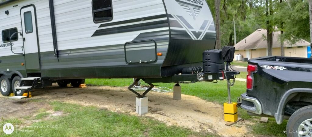 An RV with cinder blocks and tons of levelers under the front of their RV 