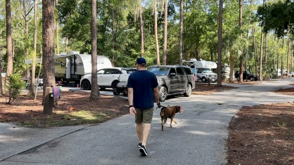 A man walking his dog at Disney fort wildness 