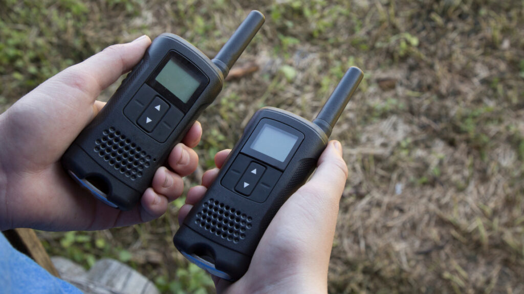 A person holding walkie talkies