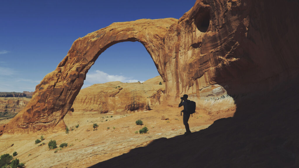 A person taking a photo at Corona Arch