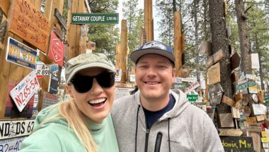 Couple smiling at the sign post forest
