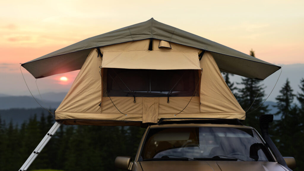 A truck with a tent on top of the roof